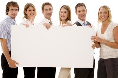group of 6 people holding white board