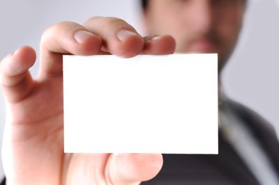 man holding white card in hand